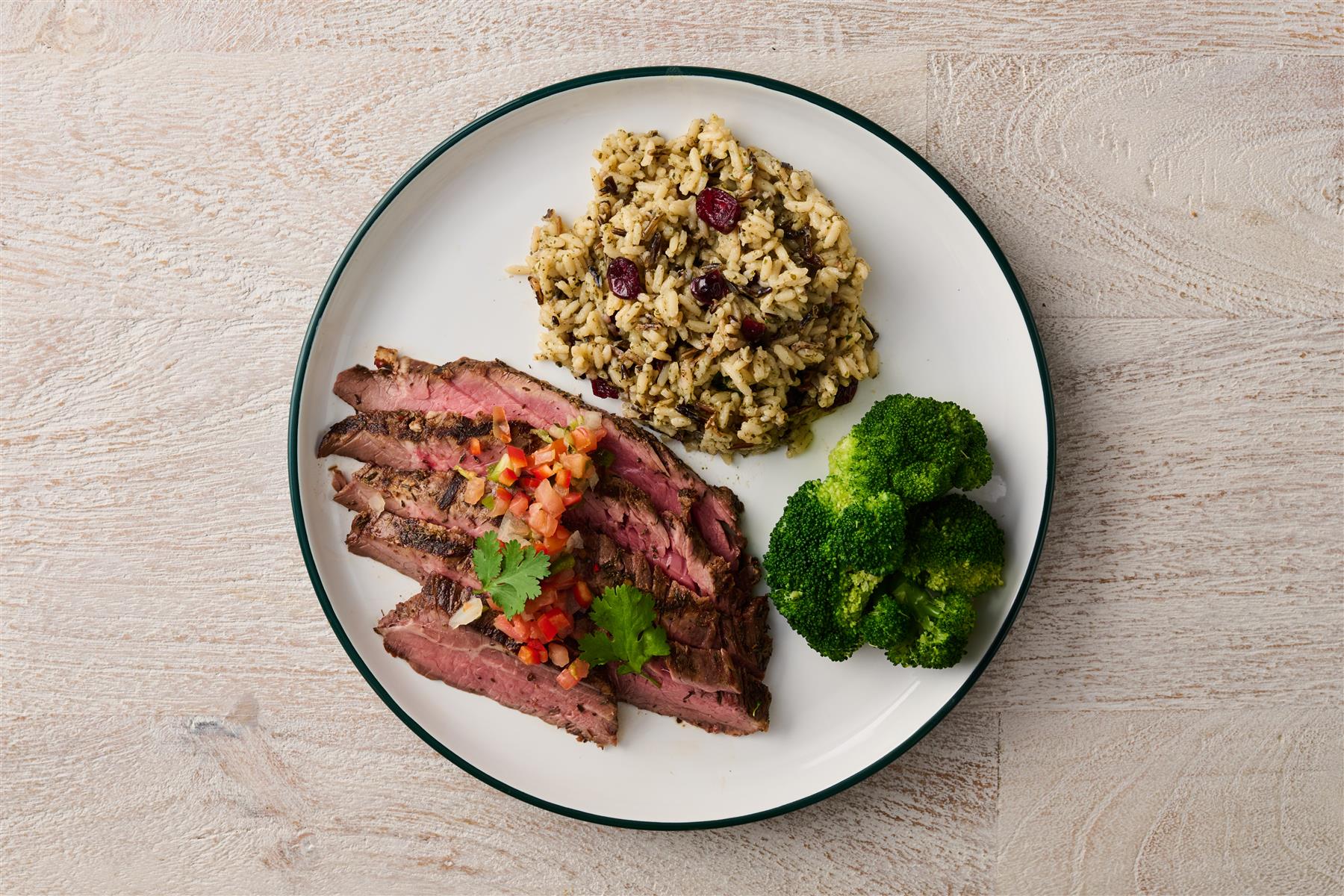 Sliced steak, wild rice, and broccoli